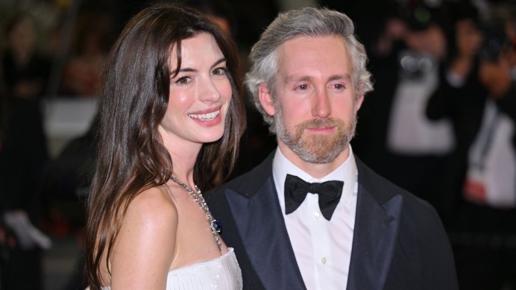 US actress Anne Hathaway (L) and her husband Adam Shulman (R) leave the Festival Palace following the screening of the film for the screening of the film âArmageddon Timeâ at the 75th annual Cannes Film Festival in Cannes, France on May 19, 2022.