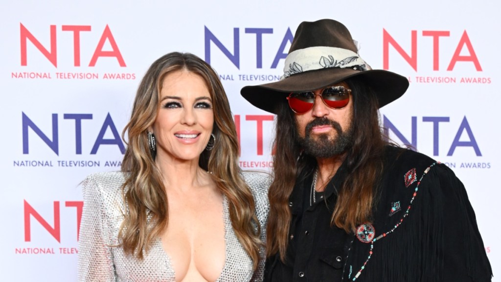 Elizabeth Hurley Shines in Sheer Silver Mesh Dress Alongside Billy Ray Cyrus