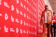 Travis Kelce Channels Showgirl in Orange Outfit Ahead of Chiefs Game