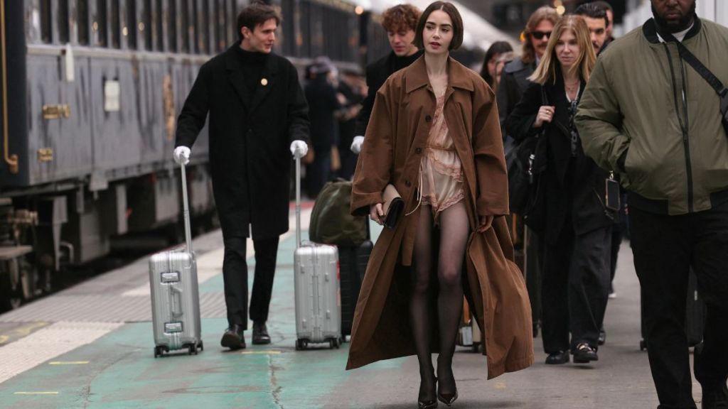 Lily Collins' Ultra Tiny Romper Is Barely Visible Under Her Large Coat