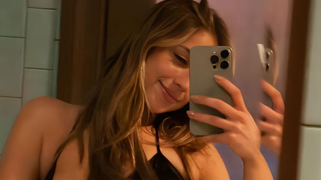 Tate McRae cami top unzipped jacket selfie