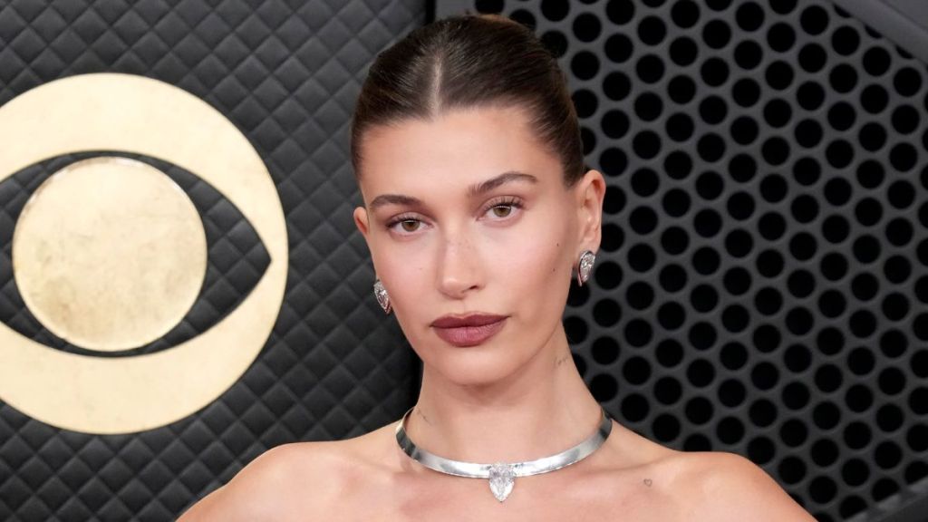 Hailey Bieber Debuts Rhode in Australia in Shirt Held by a Button