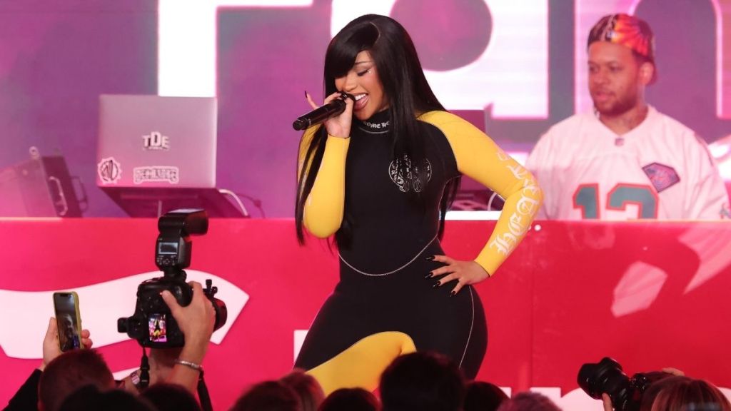 Cardi B Styles Bodysuit With Holes All Over & Sheer Tights Amid Tour